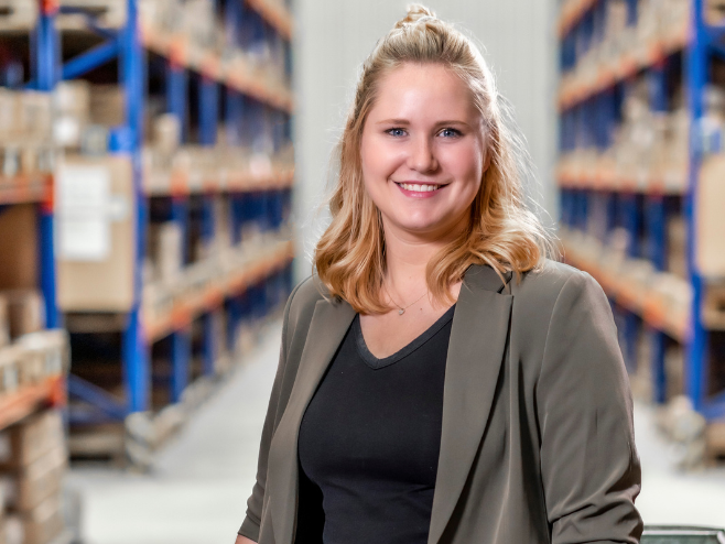 A RAMPA staff member from the Human Resources team with the RAMPA warehouse in the background.