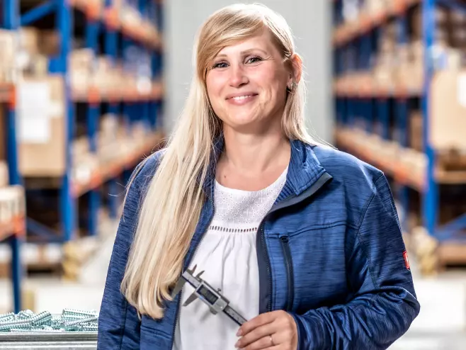 A RAMPA employee representing the Quality Assurance team with caliper gauge in hand can be seen, with the warehouse in the background.