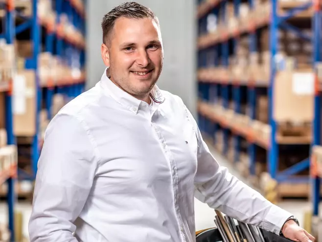 A RAMPA employee representing the Purchasing team can be seen holding a shopping basket, with the warehouse in the background.