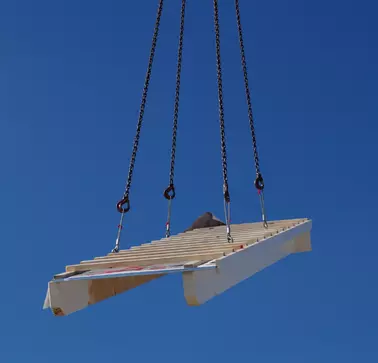 Schwabenhaus is RAMPA's reference partner. A heavy wooden element is safely lifted and moved by RAMPA's inserts type BL during the construction of a prefabricated house. The wooden element is moved by crane.