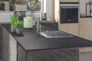 Application example of RAMPA inserts type E for HPL: Here a black kitchen countertop is shown as an example.
