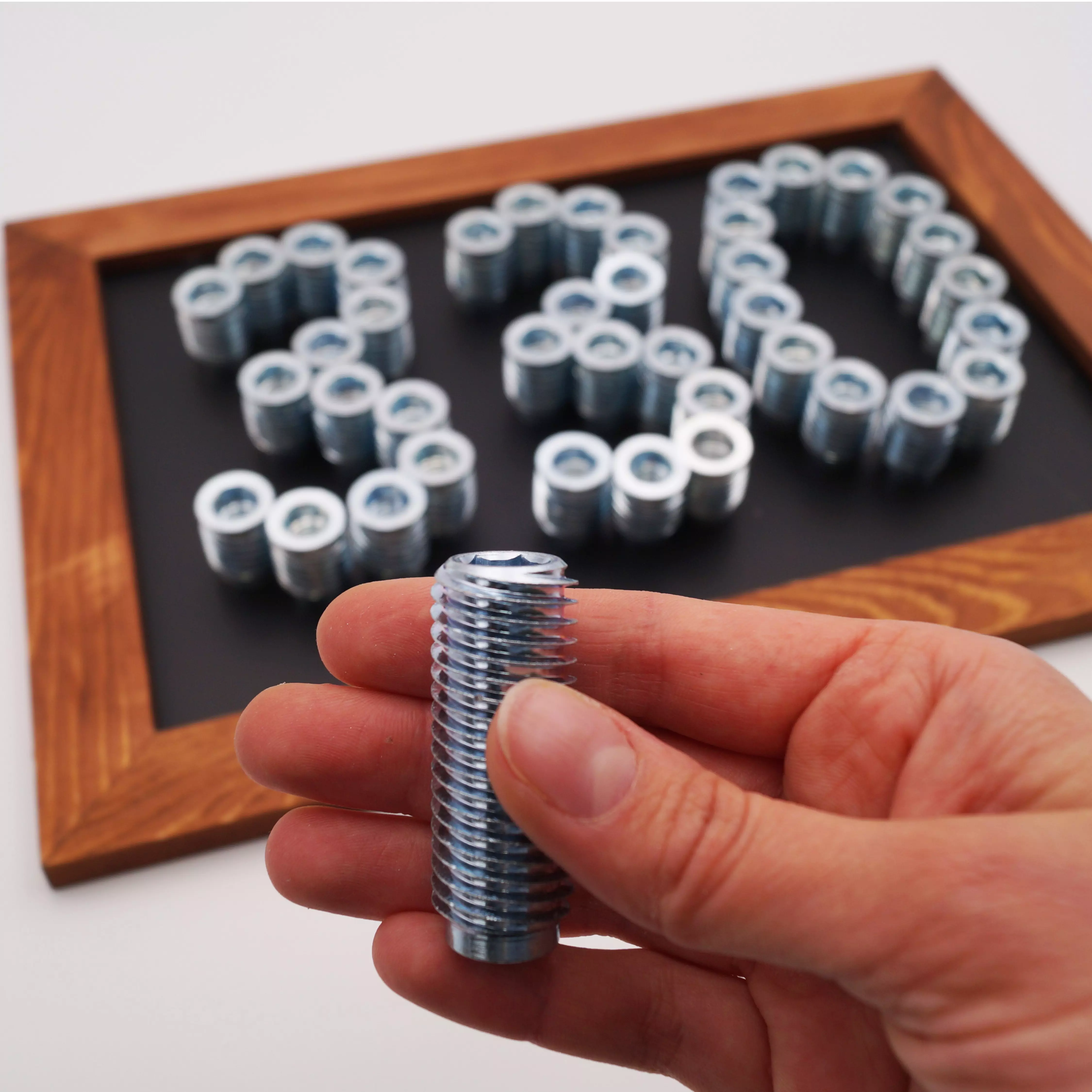 RAMPA inserts type SKL330 RAMPA insert type SKL330 is presented in the foreground. In the background is a board on which a "330" has been laid out of inserts. The 330 stands for the 330 product series, of which the SKL330 is part.