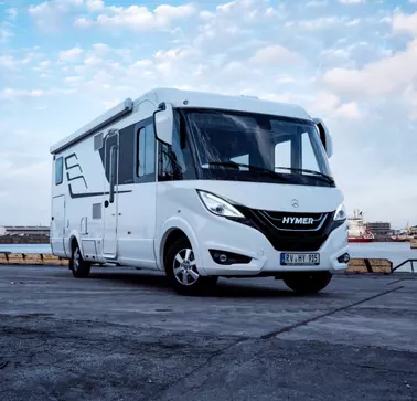 Hymer ist Referenzpartner von RAMPA. Zu sehen ist ein weißes Wohnmobil von Hymer, das auf Beton geparkt ist. In diesem Fahrzeug sind für den Innenausbau zahlreiche RAMPA-Muffen verwendet worden.